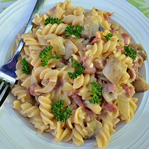 Bacon and Mushroom Pasta in a delicate, light sauce ~ This dish is ready in under 20 minutes and enough for 6 full servings