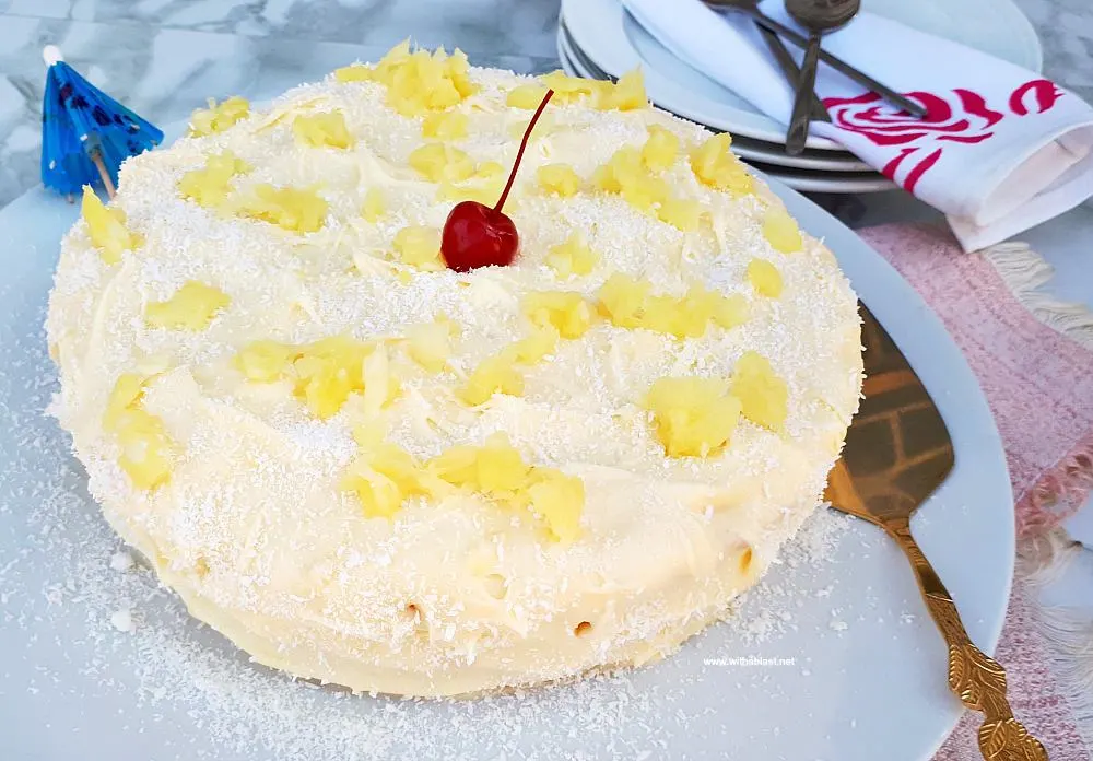Pina Colada Cake is so soft and moist with an equally delicious frosting - filled with the flavors of the tropical cocktail which just screams Summer !