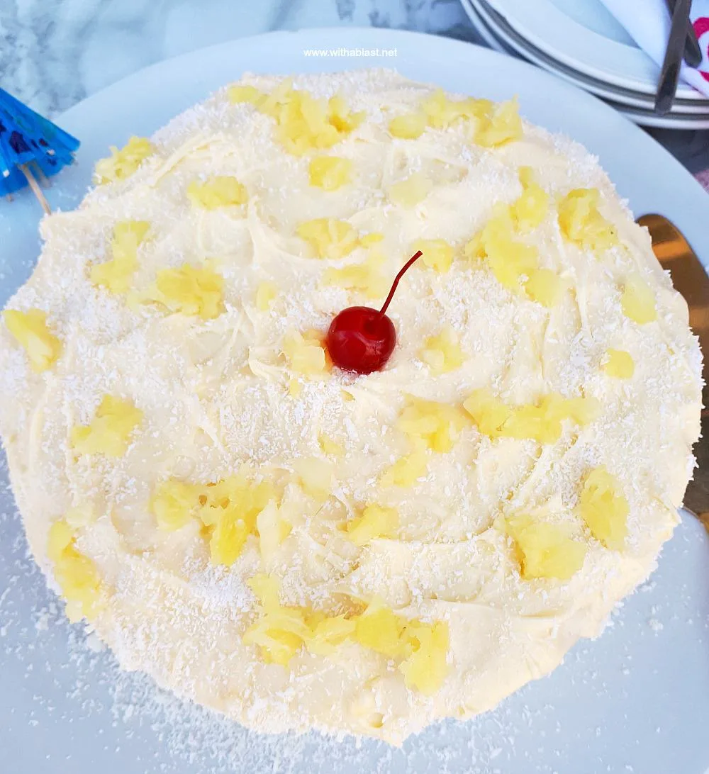 Pina Colada Cake is so soft and moist with an equally delicious frosting - filled with the flavors of the tropical cocktail which just screams Summer !