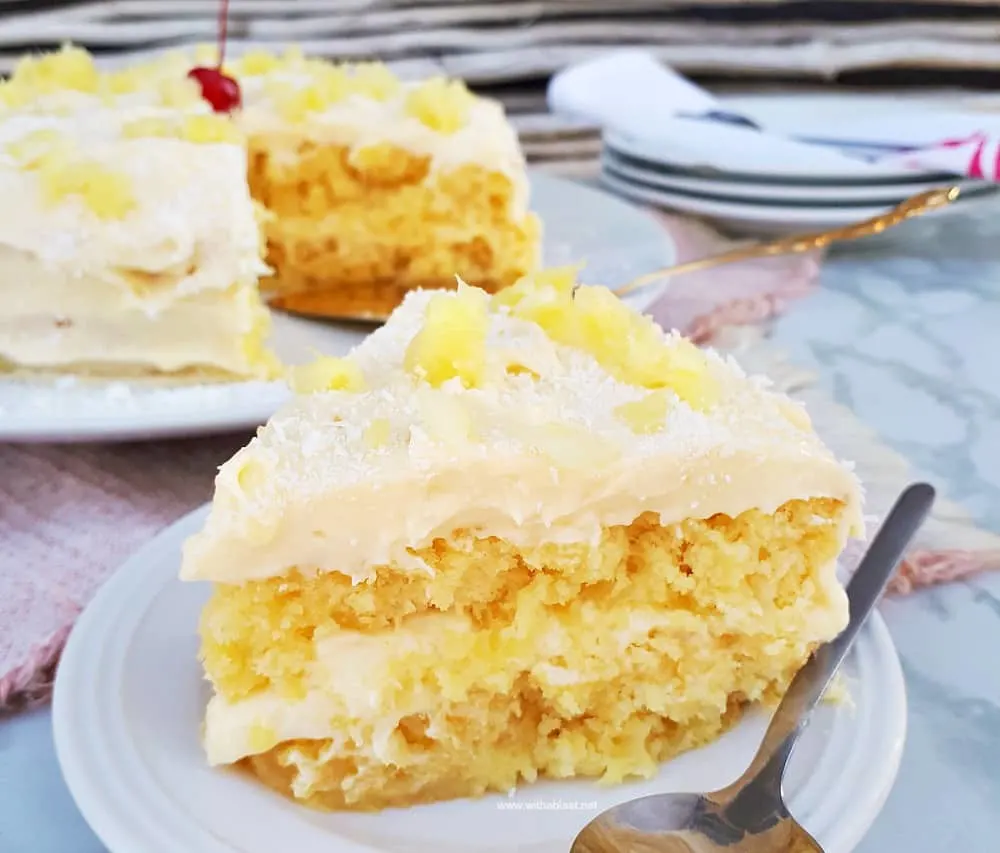 Pina Colada Cake is so soft and moist with an equally delicious frosting - filled with the flavors of the tropical cocktail which just screams Summer !