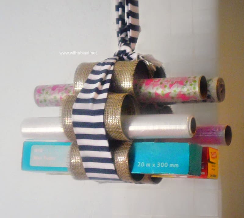 DIY Hanging Wraps Holder ~ Quick and Easy craft ! Use Empty cans to create this handy, hanging holder for all those rolls of wraps.