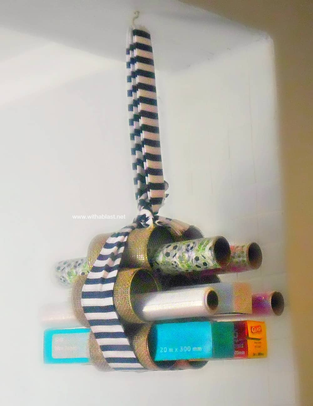 DIY Hanging Wraps Holder ~ Quick and Easy craft ! Use Empty cans to create this handy, hanging holder for all those rolls of wraps.