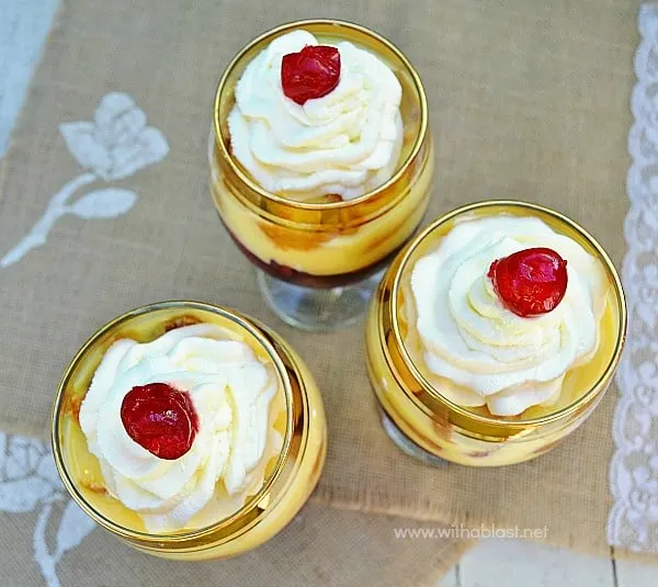 Strawberry Liqueur Trifles ~ Boozy Jello made from fresh Fruit Juice, combined with Custard, Strawberries, Swiss Roll slices and topped with Cream and a Cherry make these Individual {or one huge!} trifles a winner each and every time!