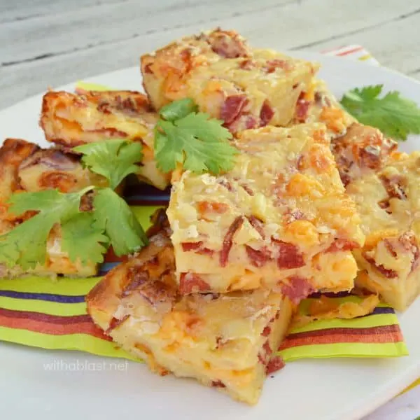 Cheesy Pepperoni Bars are serious snacking stuff ! Gooey, crunchy and tastes like a slice of Pizza and leftovers are perfect for the lunchbox.