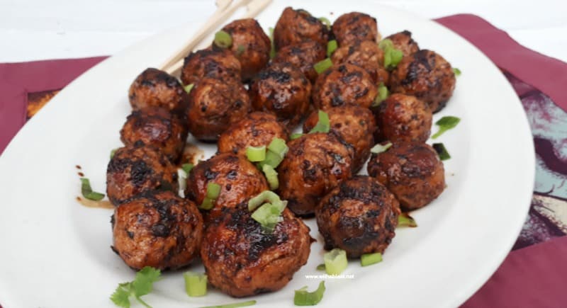 Slightly spicy, juicy Asian Chicken Meatballs, with a salty/sweet glaze are perfect to serve as an appetizer or as part of your savory party platter - make-ahead friendly recipe