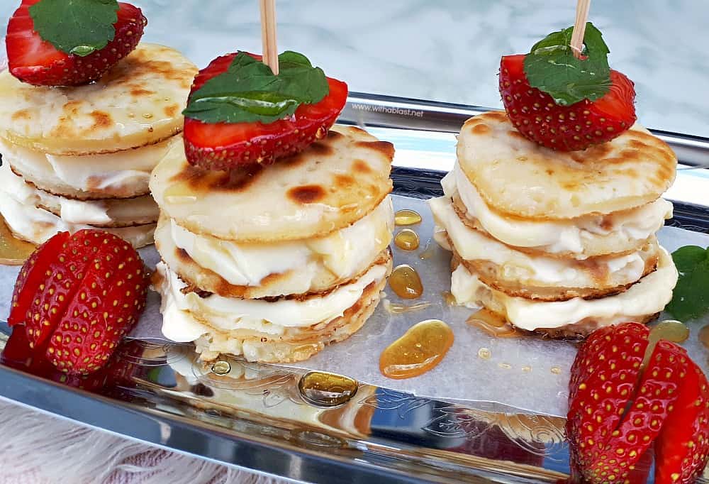 Deliciously Mascarpone Filled Mini Pancakes Stacks are perfect for a special breakfast, brunch or even a sweet treat. Perfect with Strawberries and drizzled with Honey!