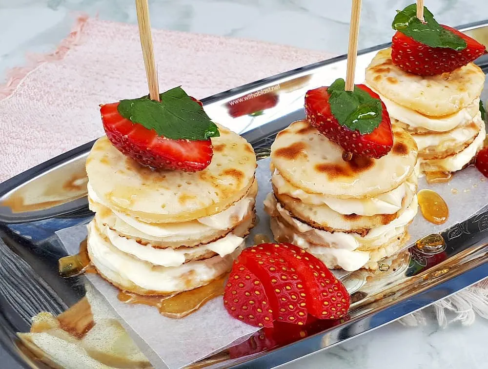 Deliciously Mascarpone Filled Mini Pancakes Stacks are perfect for a special breakfast, brunch or even a sweet treat. Perfect with Strawberries and drizzled with Honey! #PancakeStacks #MiniPancakes #FilledPancakes #BreakfastRecipes #SweetTreatRecipes